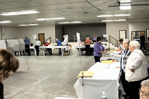 Different precincts in different stages of sorting and counting ballots.